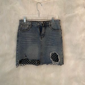 Distressed denim fishnet skirt
